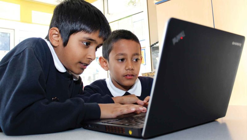 Children working on a computer (pre-covid)