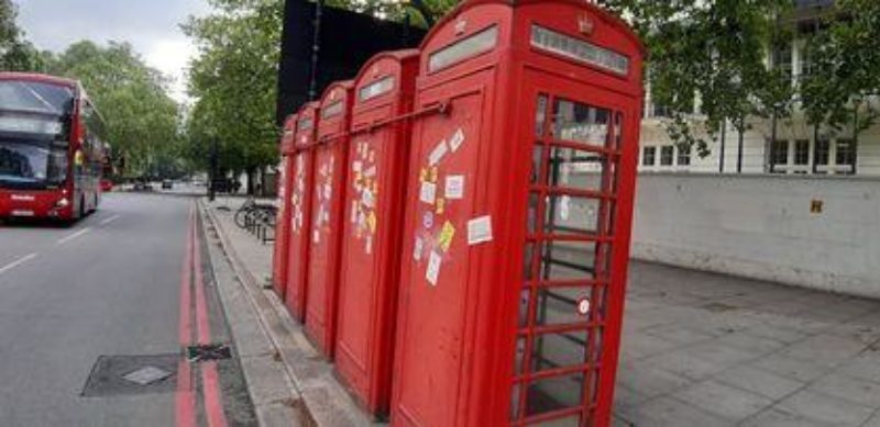 Flyposted phone boxes before