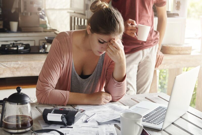 <a href="https://www.freepik.com/free-photo/thoughtful-stressed-young-female-sitting-kitchen-table-with-papers-laptop-computer-trying-work-through-pile-bills-frustrated-by-amount-domestic-expenses-while-doing-family-budget_9532744.htm#query=cost%20of%20living&position=22&from_view=search&track=ais">Image by wayhomestudio</a> on Freepik