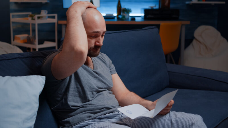 Image by Freepik of an anxious man reading a sad letter